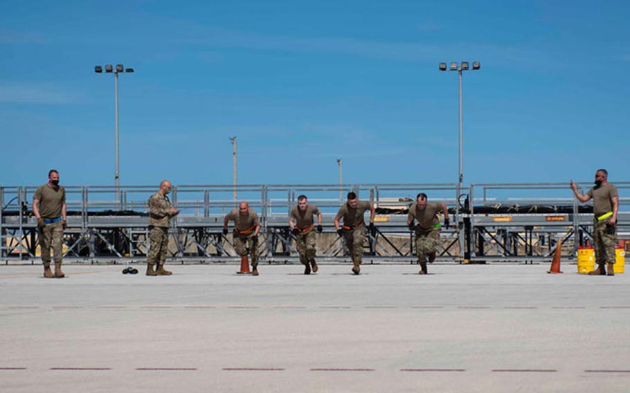 Airmen from the Air Mobility Operations Wing sprint through the physical relay part of the Port Dawg Rodeo events at Andersen Air Force Base, Guam, Feb. 11, 2021. Members from the AMOW are here in support of exercise Cope North 21 and are participating in the rodeo to sharpen their skills, build comradery and improve proficiency. (U.S. Air Force photo by Senior Airman Helena Owens)