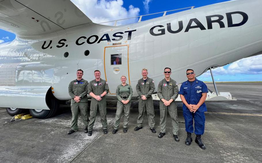 A U.S. Coast Guard Air Station Barbers Point HC-130J Hercules aircrew stands for a photo with the U.S. Coast Guard Forces Micronesia/Sector Guam engineering officer after transporting FN200 fire suppression bottles to Guam on Nov. 9, 2022. The aircrew provided support when commercial methods would preclude one of the Guam-based fast response cutters from getting underway in time for a scheduled patrol. (U.S. Coast Guard photo by Chief Warrant Officer Sara Muir)