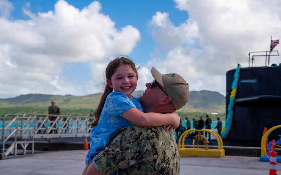 Chief Information Systems Technician (Submarine) Shane Beattie, assigned to the Los Angeles-class fast-attack submarine USS Key West (SSN 722), hugs his daughter during a homecoming celebration held at U.S. Naval Base Guam, Nov. 18. Key West conducted surveillance, training, and other critical missions in the U.S. 7th Fleet area of operations. (U.S. Navy photo by Lt. Eric Uhden)