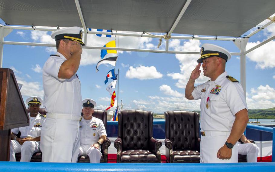 Capt. John Frye, left, relieves Capt. Albert Alarcon as commanding officer of the Emory S. Land-class submarine tender USS Frank Cable (AS 40), during a change of command ceremony held aboard the ship, May 23. Frank Cable is one of two U.S. Navy submarine tenders that provide maintenance, hotel services, and logistical support to submarines and surface ships in the U.S. 5th and 7th Fleet areas of operation. (U.S. Navy photo by Mass Communication Specialist Seaman Wendy