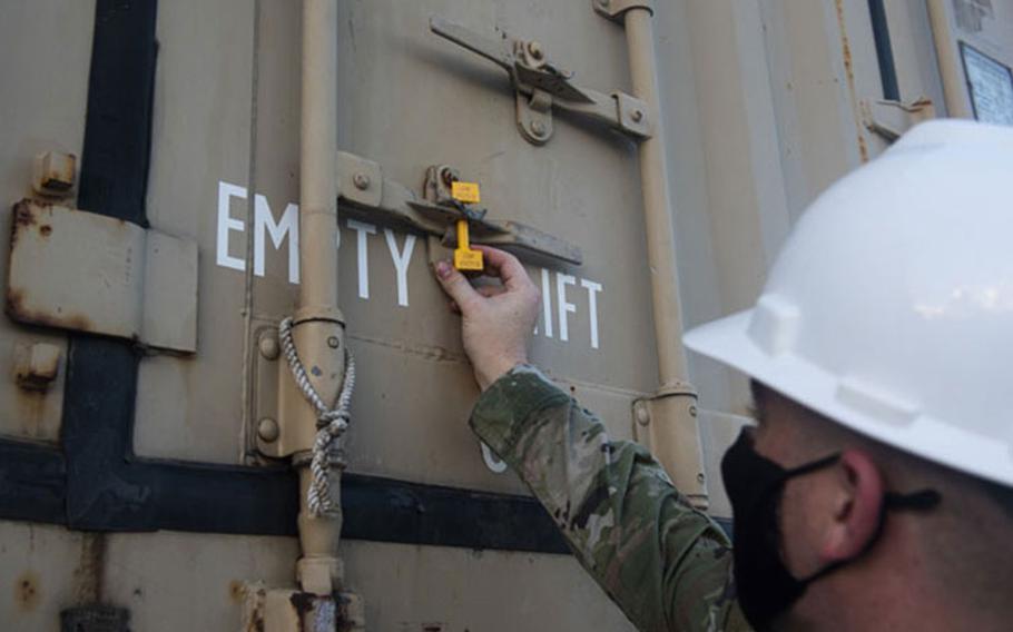 U.S. Air Force Staff Sgt. Adam Doutrich, a stockpiler supervisor assigned to the 36th Munitions Squadron, inspects a seal on a storage container at Naval Base Guam, Nov. 15, 2020. The Navy and the Air Force continue to develop and maintain operational compatibility by completing munition transport operations while also ensuring combat readiness to both forces. (U.S. Air Force photo by Senior Airman Michael S. Murphy)