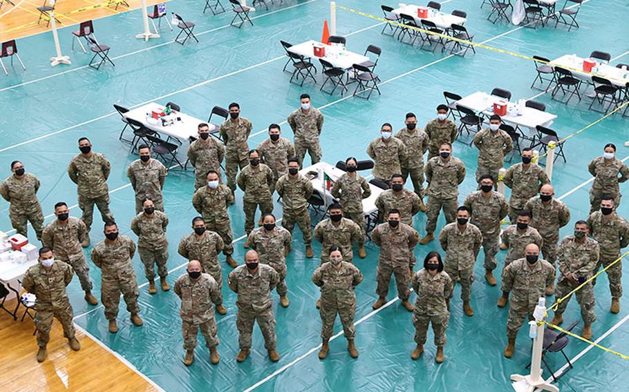 Members of Task Force Medical and Task Force Response, under the Guam National Guard’s Joint Task Force 671 and in support of the Guam Department of Public Health and Social Services, form up for a pre-shift brief at the University of Guam Calvo Field House in Mangilao Guam on Feb. 26, 2021. The crew of approximately 40, with help from the University of Guam, DPHSS and community volunteers, can administer over 2,000 COVID-19 vaccine doses per day under Operation Liberate Guam.