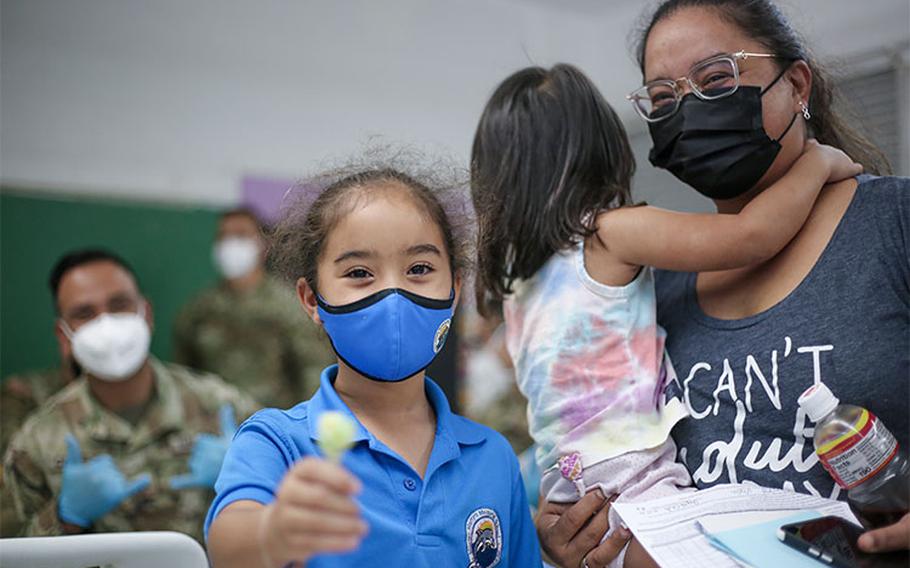 Photos by Guam National Guard: Keilah Hale, 7, of Merizo, shows off her post-vaccine treat with her mother, Marina Hale, at the Guam National Guard outreach clinic at the Merizo Elementary School on Jan, 27. "I got my first dose uptown, and it takes a long time coming from here. So having something down here in the South, it really does help a lot," said Marina Hale. Of the 90 doses given at the clinic to both children and adults, 41 were first doses.