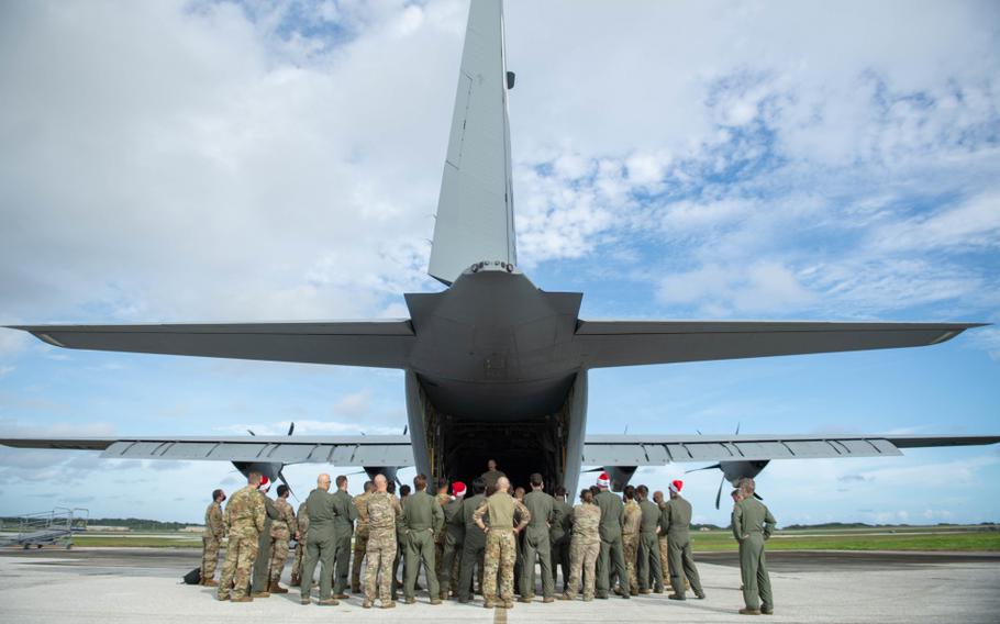 Airmen with the 374th Airlift Wing listen as Tech. Sgt. Lou Splichal, Operation Christmas Drop 2020 senior enlisted leader, talks about Senior Airman Jeremy Jutba-Hake during the 69th annual OCD at Andersen Air Force Base, Guam, Dec. 10. (U.S. Air Force photo by Staff Sgt. Gabrielle Spalding)