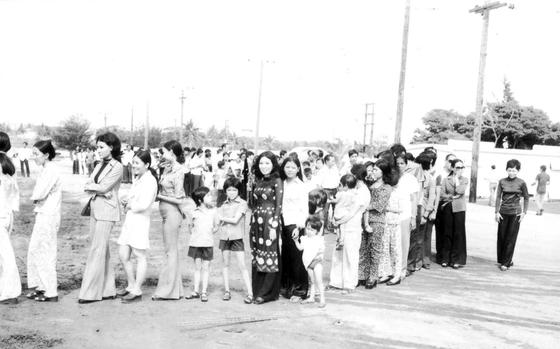 Photo Of New Life refugees waiting in line at Andersen’s “Tin City” barracks.