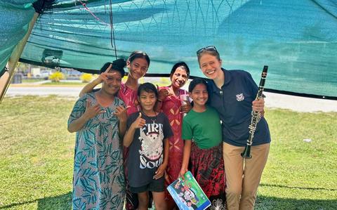 Photo Of A member of the U.S. Coast Guard Band stands with locals after a performance at Delap Park in Majuro, Republic of the Marshall Islands, on June 6, 2025. The U.S. Coast Guard conducted a successful engagement strengthening partnerships and promoting boating safety in Majuro, Republic of the Marshall Islands.