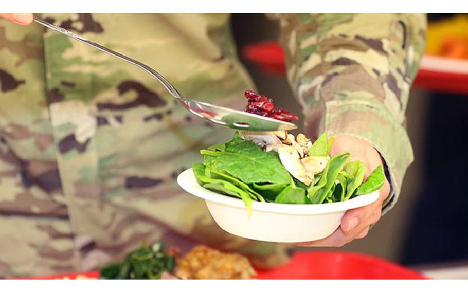 A student from the U.S. Army John F. Kennedy Special Warfare Center and School (USAJFKSWCS) creates a salad at the USAJFKSWCS dining facility at Fort Bragg, North Carolina. (U.S. Army photo by K. Kassens)