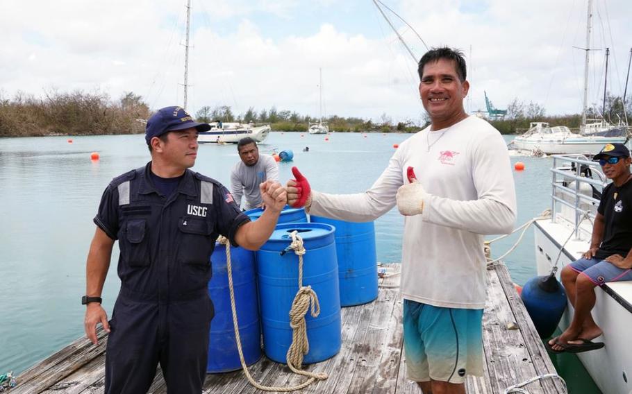 Chief Petty Officer Roderick Bawar, a Marine Science Technician stationed at U.S. Coast Guard Forces Micronesia / Sector Guam, speaks to local mariners while conducting port assessments in Guam May 29, 2023, following Typhoon Mawar. Typhoon Mawar hit Guam with maximum sustained winds of 140 mph and gusts of up to 165 mph, the equivalent of a Category 4 hurricane. (U.S. Coast Guard photo by Petty Officer 3rd Class David Graham)