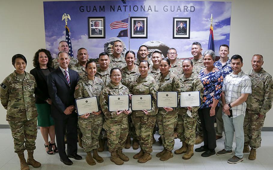 Steven B. Merrill, special agent in charge of the Federal Bureau of Investigations' Honolulu Field Office, third from left, awarded members of the Guam National Guard's 94th Civil Support Team and Defense Enrollment Eligibility Reporting System office with certificates of appreciation in Barrigada on March 15.