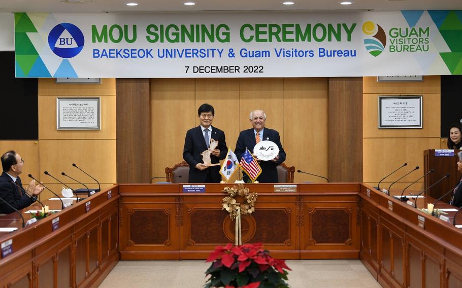 Baekseok University Vice President for Academic Affairs Woo Jin Jung (left) and Guam Visitors Bureau President & CEO Carl T.C. Gutierrez (right) exchange gifts during the MOU signing ceremony on December 7, 2022.