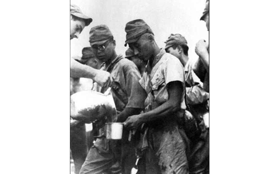 An American soldier gives water to youthfullooking Japanese prisoners of war. In the fury and rage of battle, men often forgot that those they were killing were in most respects just like them. As the old saying goes, “All men bleed red.” Photo courtesy of War in the Pacific National Historic Park