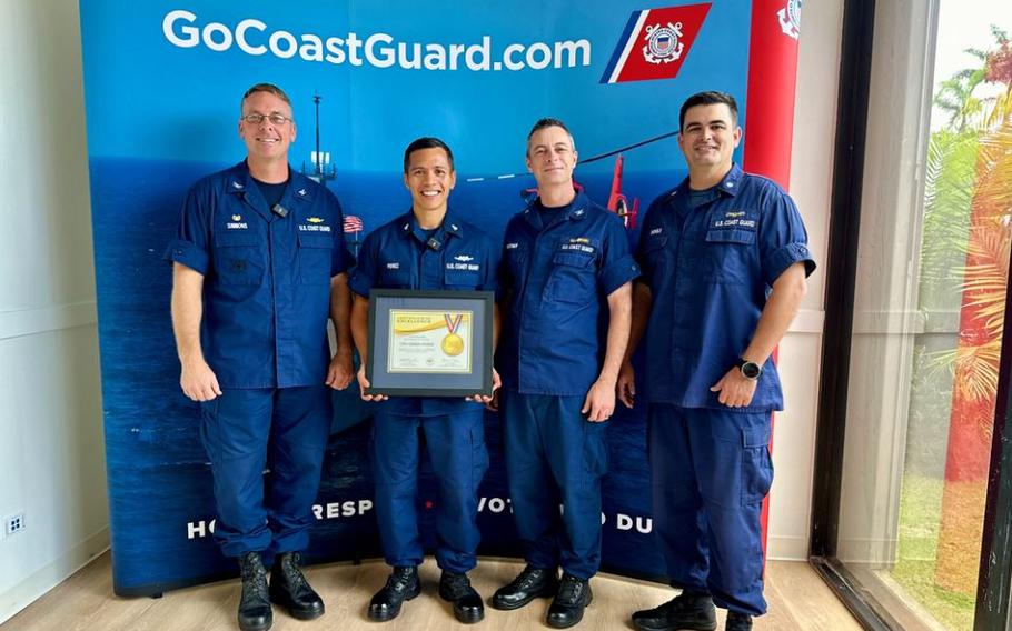 Chief Petty Officer Deren Perez, a figure of inspiration and leadership within the U.S. Coast Guard, is presented with the U.S. Coast Guard’s Elite Male Athlete of the Year award by the U.S. Coast Guard Forces Micronesia Sector Guam command at the newly relocated recruiting office in Tamuning, Guam.