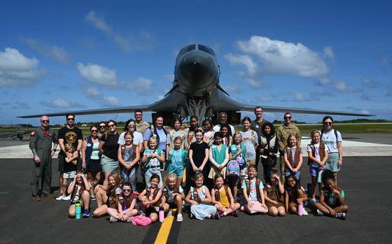 The Andersen Air Force Base Girl Scouts, parents and pilots pose in front of a B-1 Lancer on Andersen AFB, Guam, Feb. 8, 2025.