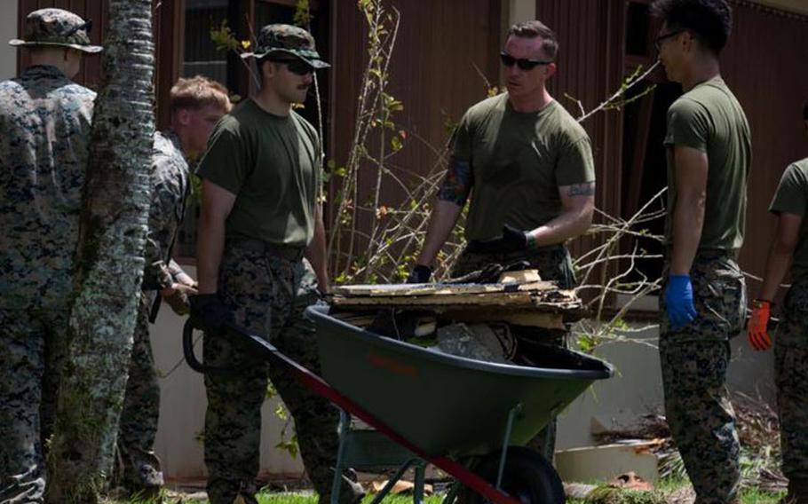 U.S. Marines assigned to the Marine Aviation Logistics Squadron – Forward, Marine Corps Air Station Miramar, California,, clean up debris after Typhoon Mawar at Andersen Air Force Base, Guam, June 2, 2023. Typhoon Mawar was a category four storm, producing winds of at least 130 mph (209 km) making it one of the strongest typhoons to hit Guam in decades. (U.S. Air Force photo by Airman 1st Class Emily Saxton)