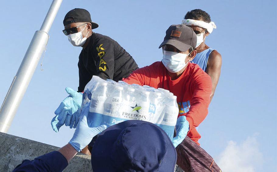 The crew of the Coast Guard Cutter Myrtle Hazard (WPC 1139) deliver emergency supplies to the island of Kayangel, Palau, following Typhoon Surigae, April 24, 2021.The supplies included water and food for the people of Kayangel. (U.S. Coast Guard photo courtesy of Petty Officer 3rd Class Philip Groff/Released)