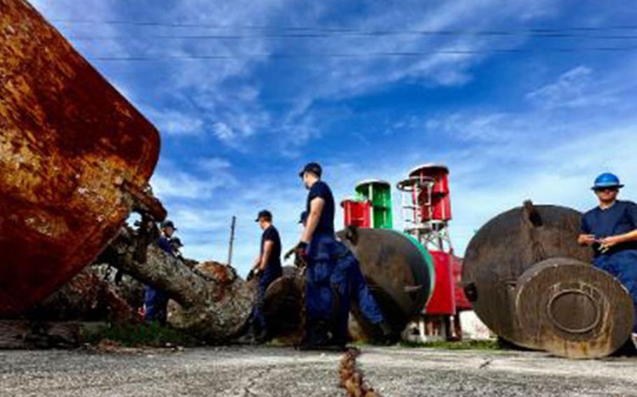 The USCGC Hickory (WLB 212) crew chain buoys, used as aids to navigation, together during storm preparation at U.S. Coast Guard Forces Micronesia/Sector Guam ahead of Tropical Storm Bolaven on Oct. 9, 2023. Tropical Storm Bolaven strengthened after passing through the Federated States of Micronesia and is forecast to intensify through Tuesday afternoon, possibly becoming a typhoon. (U.S. Coast Guard photo by Chief Warrant Officer Sara Muir)