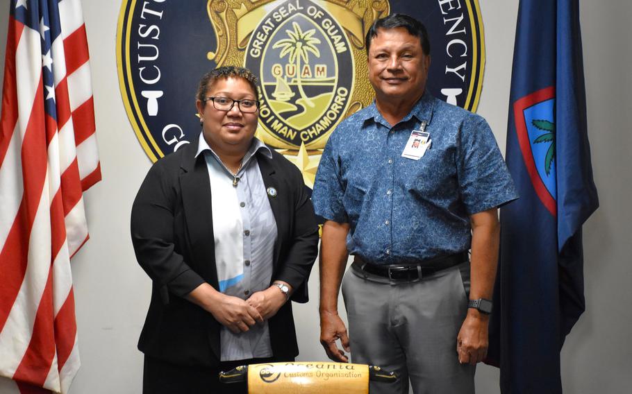 Oceania Customs Organisation (OCO) Head of Secretariat, Nancy Oraka, left, and Guam Customs and Quarantine Agency (CQA) Director Ike Peredo are photographed with a traditional Fijian lali, or drum, in October 2024 at the CQA headquarters.