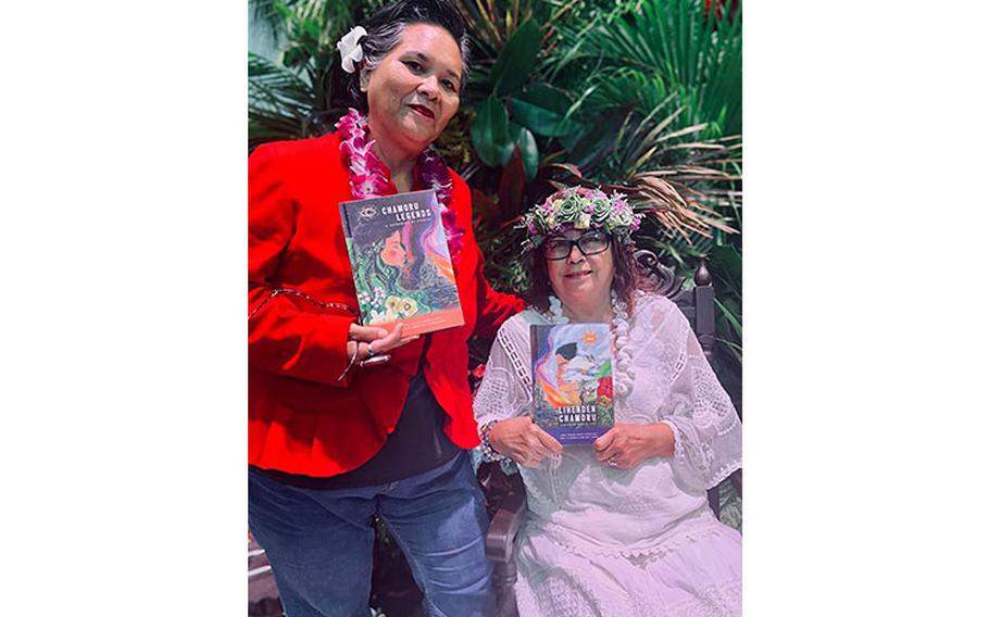 Author Teresita Lourdes Perez, left, and CHamoru translator Maria Ana Tenorio Rivera hold copies of their book, “CHamoru Legends: A Gathering of Stories” at the book’s launch on Nov. 14. The double-sided dual-language book was announced this month as a winner of an Independent Publisher Book Award for Best Regional Fiction. (Photo courtesy of the University of Guam)