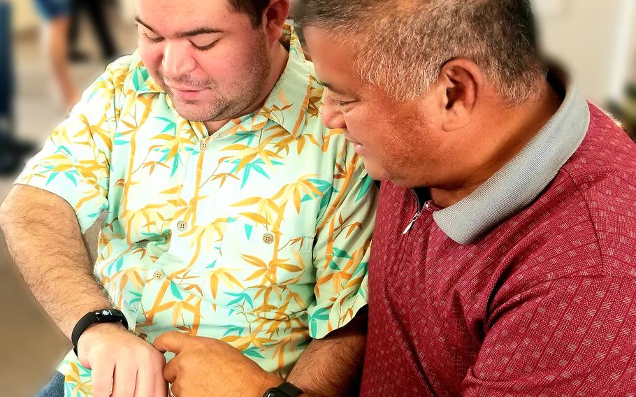 Photos courtesy of the University of Guam: Christopher Mafnas, left, and Joseph Mafnas review the daily activity tracked by a Fitbit as part of the national DETECT study, an app-based study that analyzes participants’ heart rate, activity, and sleep data to reveal patterns preceding influenza-like illnesses and possibly other viral infections, such as COVID-19.