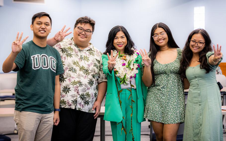 Dr. Anita Borja Enriquez, center, and members of the UOG Student Government Association show the Triton sign following the selection of Dr. Enriquez as the next UOG president. Photos courtesy of UOG