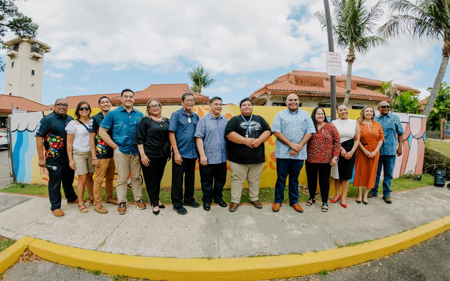 Community leaders stand in support of Guam Green Growth Art Corps muralist Kamaka Aquino at the CHamoru Village in Hagatna.