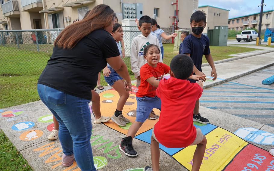 Theo Manglona, a child who attends the child care center at Ironwood Villa Del Mar, lands on a gameboard space that requires 10 squats.