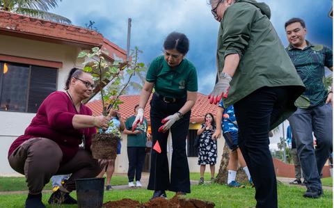 Photo Of UOG and CHamoru Village leadership plant a fruit tree on the grounds of the CHamoru Village.