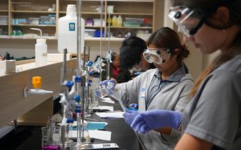 Zoe Leung of Harvest Christian Academy pours sodium hydroxide into a burette during the UOG Chemistry Titration Competition on March 7.