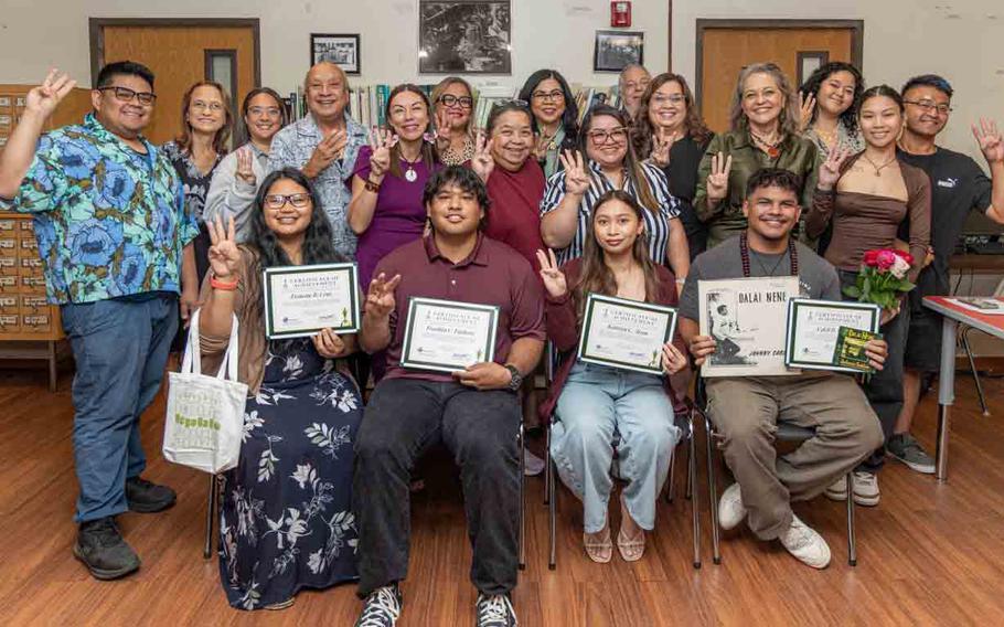 L-R front row: Awardees Francine Cruz, Franklin Fujihira, Katielyn Aizon, and Caleb Cruz surrounded by family, friends, UOG administrators, and the family members of the CHamoru authors and songwriters who were honored through the awards.