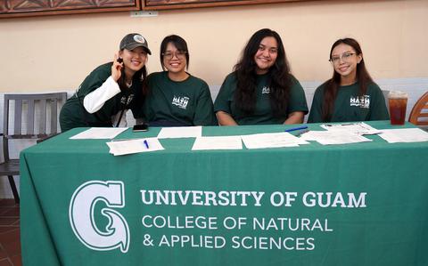 Photo Of UOG math and computer science majors Yoonji Seo, Lydia Sombria, Shannon Ada, and Joriza Luzano assist with registration at UOG Math Day.