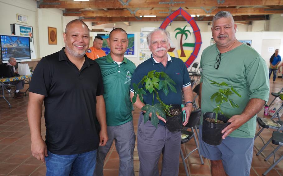 Mark Acosta, Glenn Takai, Bob Barber, and Frank Quinata hold papaya plants that were given out during a soil workshop for farmers hosted by University of Guam Cooperative Extension & Outreach and the Southern Soil & Water Conservation District.