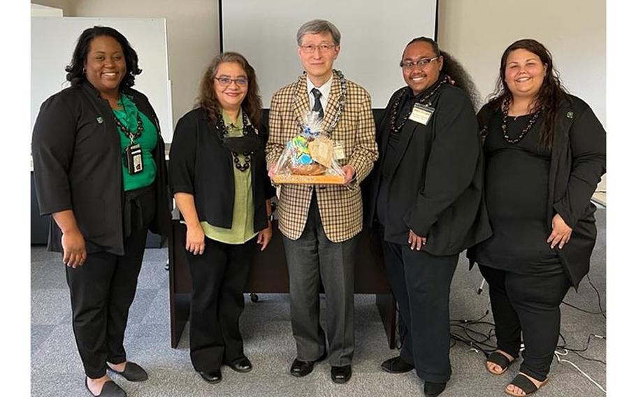 Dr. Akihiro Noguchi of Nagoya University, center, is seen with some of the University of Guam representatives on the first day of the International Conference on Business, Economics and Information Technology (ICBEIT) on March 13, 2023, at the conference's Nagoya satellite venue. With him from left: Jackysha Green, assistant professor of elementary education; Joann Diego, assistant professor of Human Resources Management and co-chair of the Nagoya satellite; and HRM students Denzyl Ngiralmau and Jamie Freit