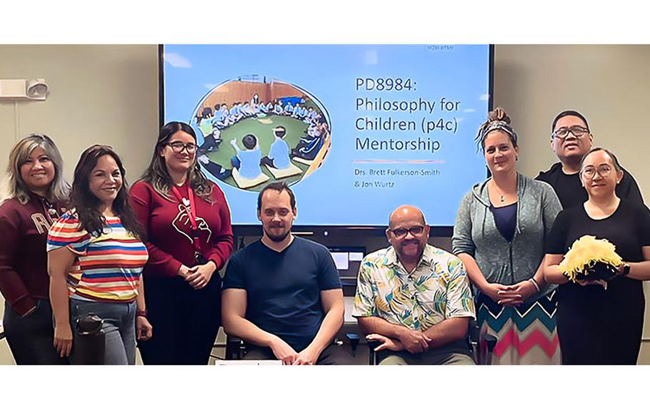 Dr. Jonathan Wurtz and Dr. Brett A. Fulkerson-Smith, seated, respectively, gather for a photo with course participants during a January 2023 training on Philosophy for Children at the University of Guam.