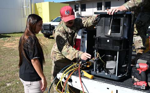 Photo Of U.S. Air Force Tech. Sgt. Ronald Gottus, 554th Rapid Engineer Deployable Heavy Operational Repair Squadron Engineers Squadron, explains how an Air Conditioning Unit operates to a student at Tiyan High School, Guam
