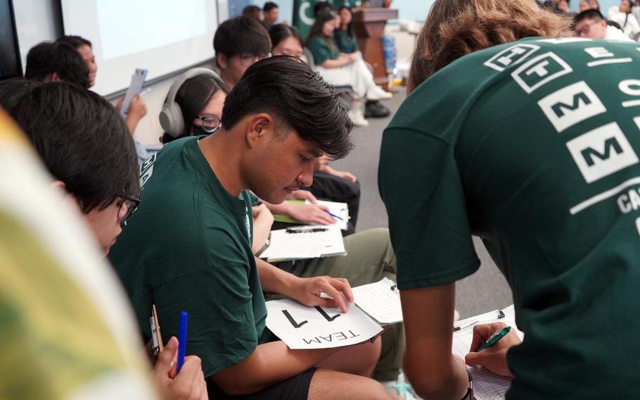 UOG student Michael Tenorio reviews scores as a volunteer judge for the Math Quiz Competition at UOG Math Day on Nov. 16, 2024,.