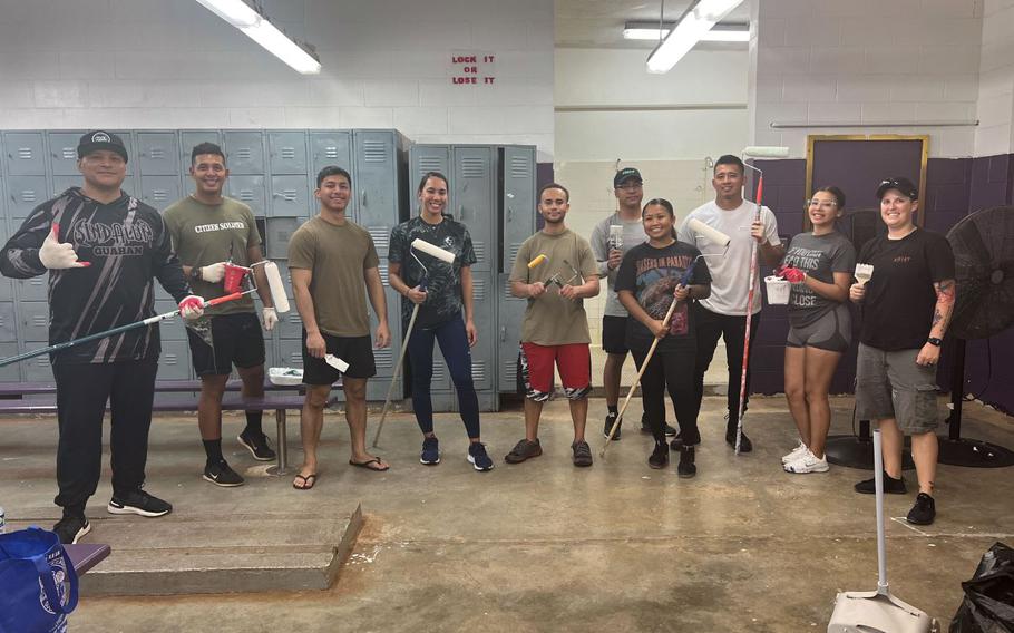 U.S. Air Force Airmen from the 36th Wing pose mid-cleaning and painting at George Washington High School in Mangilao, Guam, August 23, 2024.