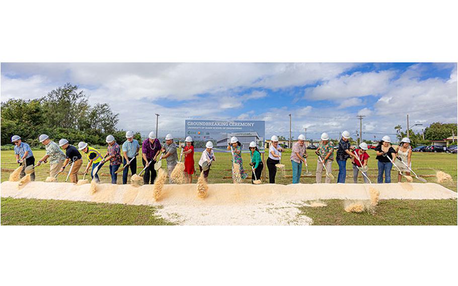 Dr. Anita Borja Enriquez, 11th from left, and Gov. Lou Leon Guerrero, 10th from left, lead the ceremonial shoveling of sand at the groundbreaking for the School of Engineering building on campus on Friday, December 15, 2023.  Photo courtesy of University of Guam