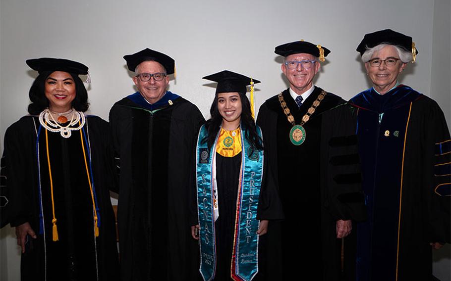 Photos courtesy of the University of Guam: (From left) Anita Borja Enriquez, senior vice president and provost; Lee S. Yudin, dean of the College of Natural and Applied Sciences; Darlene Ferrer, class valedictorian and chemistry-biology dual bachelor’s recipient; Thomas W. Krise, president; and Kate Moots, interim associate dean, CNAS.