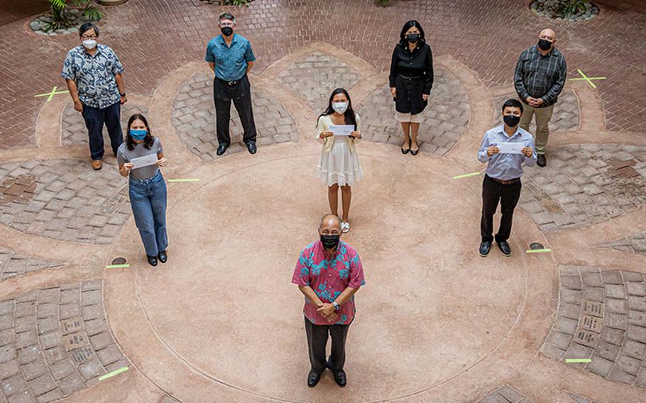 Photo courtesy of University of Guam: (Back row, from left) Mark Duarte, UOG director of Financial Aid; Thomas W. Krise, UOG president; Anita Borja Enriquez, UOG senior vice president and provost; Lawrence Camacho, UOG dean of Enrollment Management and Student Success; (middle row, from left) Mia Nanpei; Jean Dela Cruz Bactad; Jude John Bautista; (front row) Carlos P. Camacho, manager of the Camacho Foundation.