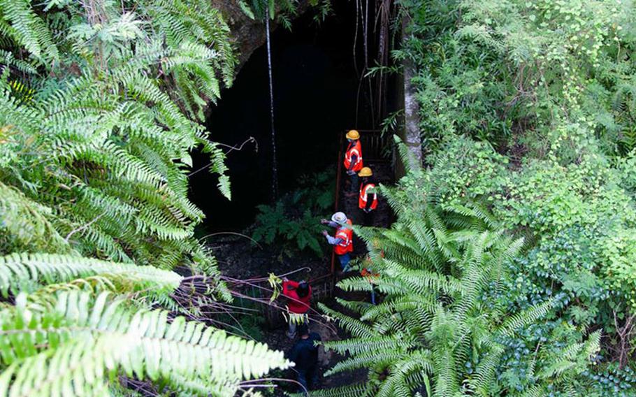 University of Guam faculty and graduate students study a sinkhole and karst terrain at Tarague Well 4 at Andersen Air Force Base Oct. 8. Navy environmental specialists escorted John Jensen, University of Guam chief hydrogeologist and professor of environmental geology, and Water & Environmental Research Institute Western Pacific director, and his graduate students to the area to study the unique karst at the Air Force Base. (U.S. Navy photo by JoAnna Delfin)