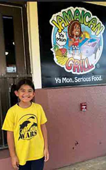 author in front of Jamaican Grill