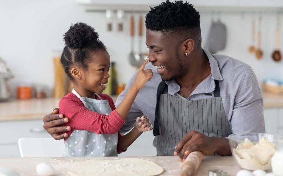 Father and daughter baking in the kitchen.