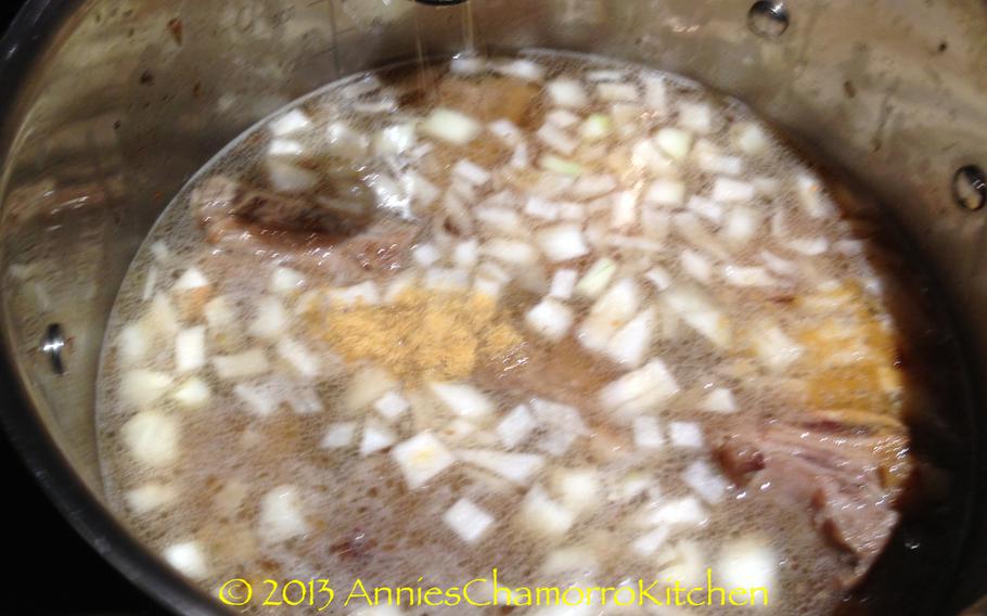 After the ribs are browned on all sides, add 8 cups of the water, the remaining onions and Dashida.