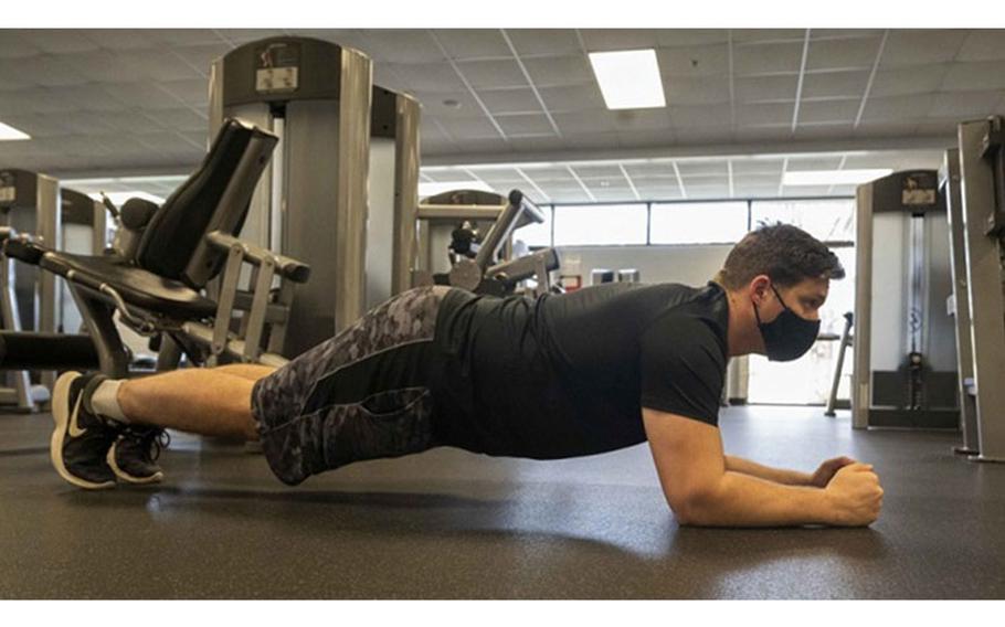 Navy Information Systems Technician 1st Class Caleb Womack performs a plank in preparation of the Physical Readiness Test at the Naval Recruiting Command in Millington, Tennessee, in February. (U.S. Navy photo by Petty Officer 3rd Class Tyler Priestley)