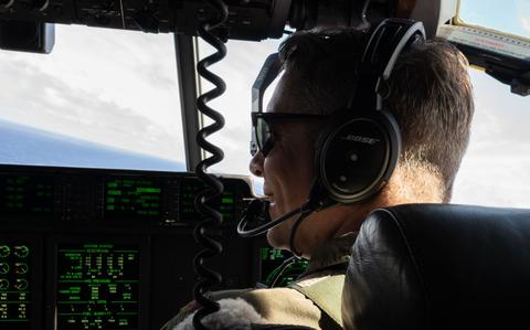 Photo Of U.S. Air Force Maj. Gavin Warmbold is smiling in the cockpit.