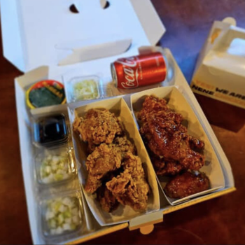 Korean fried chicken in a paper package.