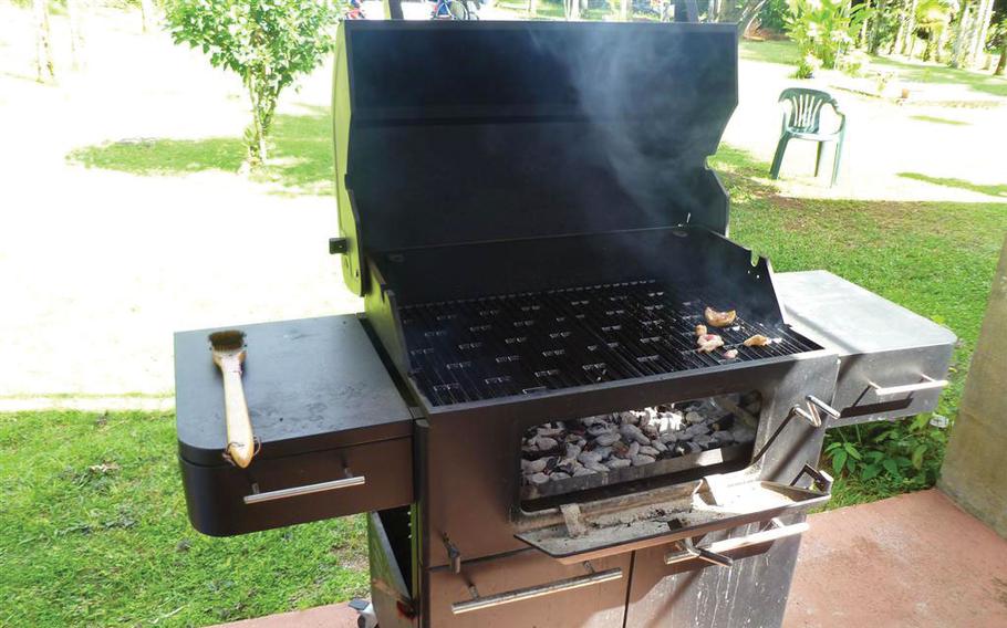 Cooking meat on a BBQ grill.