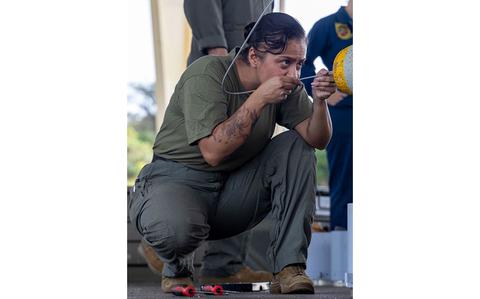 Photo Of U.S. Marine Corps Gunnery Sgt. Jessica Brewer prepares a CBU-38 cluster bomb.