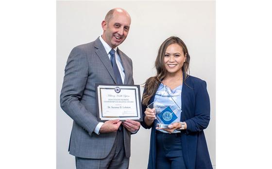 Dr. Suzanne D. Lobaton, occupational medicine supervisor with U.S. Naval Hospital Guam, receives the 2024 Civilian Nursing Leadership Excellence Award at the Military Health System Awards ceremony April 31 in Cleveland, Ohio, by Dr. Stephen Ferrara, Acting Assistant Secretary of Defense for Health Affairs. The award honors civilian registered nurses who have demonstrated exemplary leadership and skill resulting in accomplishments that improve the practice of nursing in the Military Health System.
