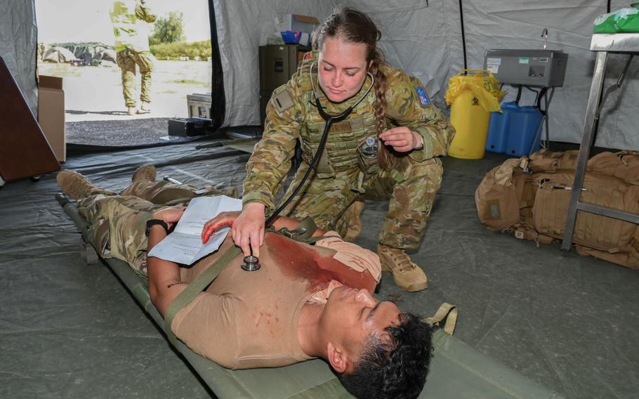 Royal Australian Air Force Flight Officer Anneka Zerbes inspects the physical condition of a simulated patient on Tinian, Feb. 11, 2024. The mass casualty exercise is part of Cope North 24, bringing six nations together for continued collaboration and integration of dispersed operations amongst Allies and partners to create an asymmetric advantage through access, interoperability, increased partner capacity, and increased domain awareness.